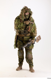 Andrew Elliott in Ghillie Pose with Gun holding gun standing…